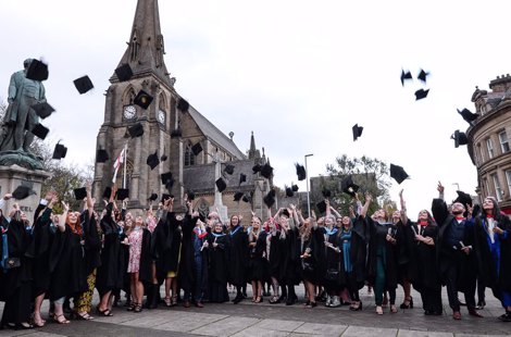 Graduates throwing their hats into the air