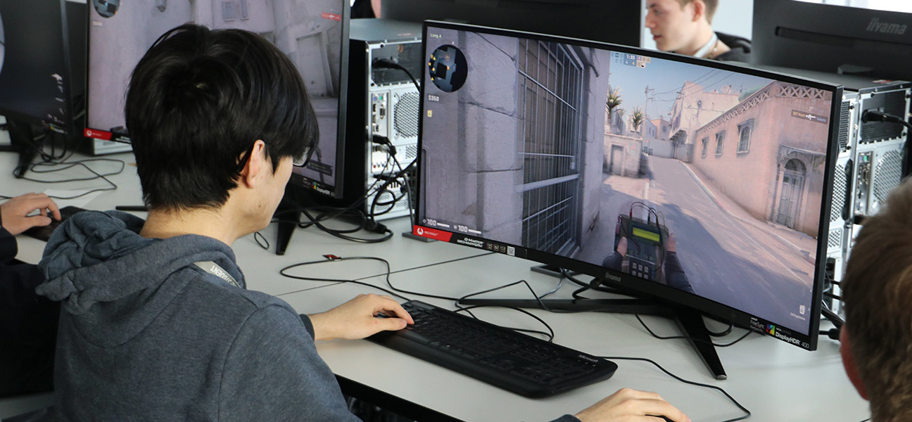 Student playing video games on a computer