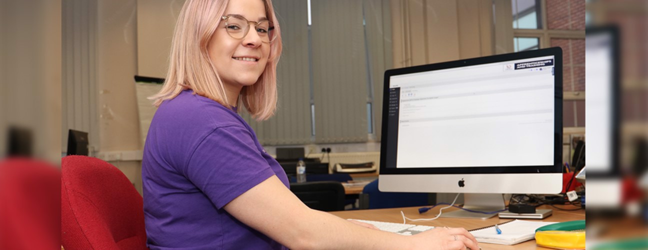 Adult Care Worker Level 2 apprentice, Mollie Cooper sat at a computer