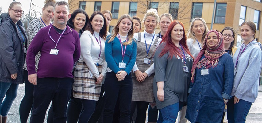 Group of Bury College University Centre students stood in front of the University Centre