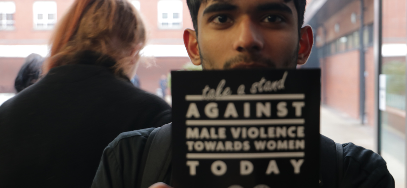 Students holding a leaflet - White Ribbon Campaign