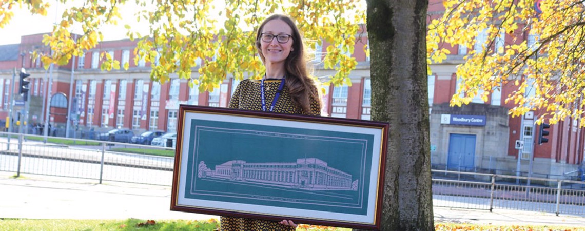 Student holding a tapestry