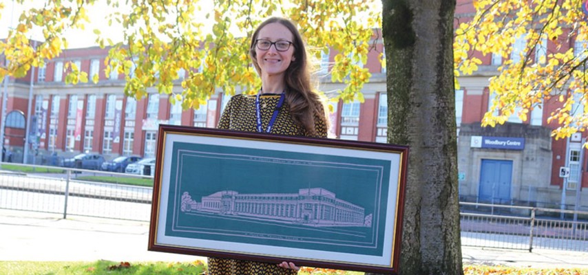 Student holding a tapestry