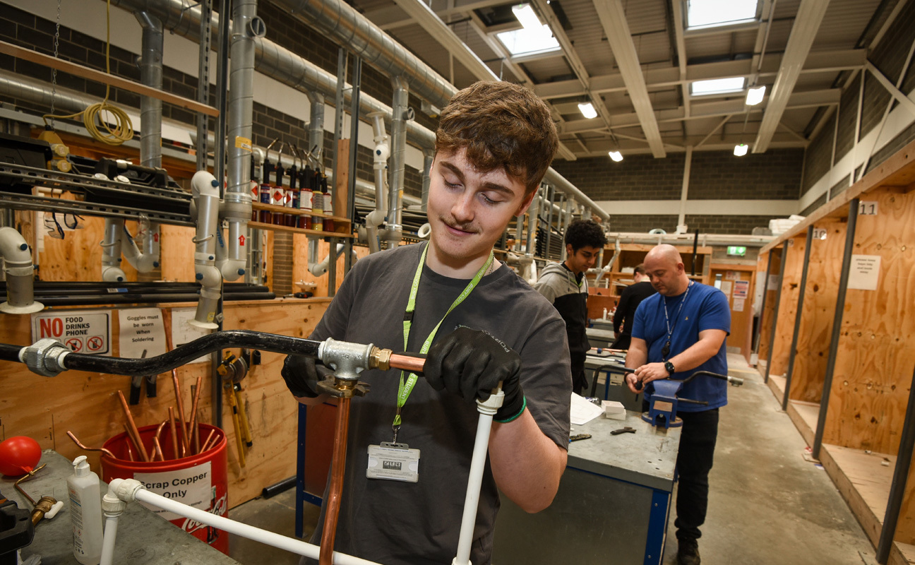Plumbing students taking part in a practical activity