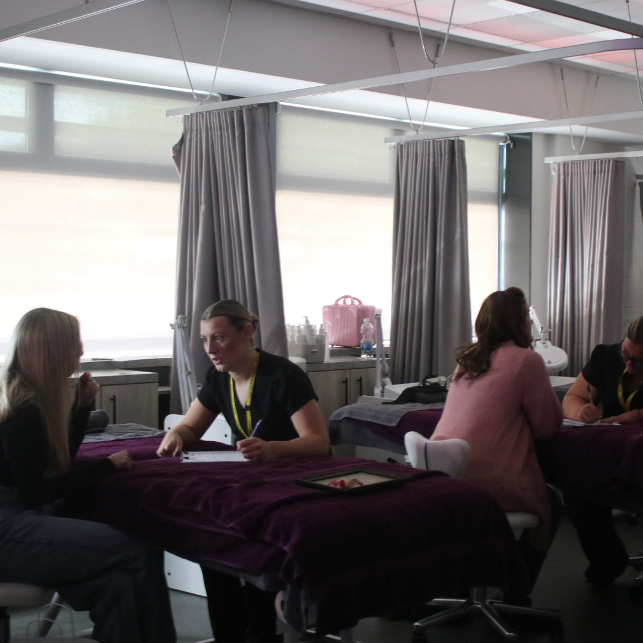 Students providing treatments at Bury College's hair and beauty employer event