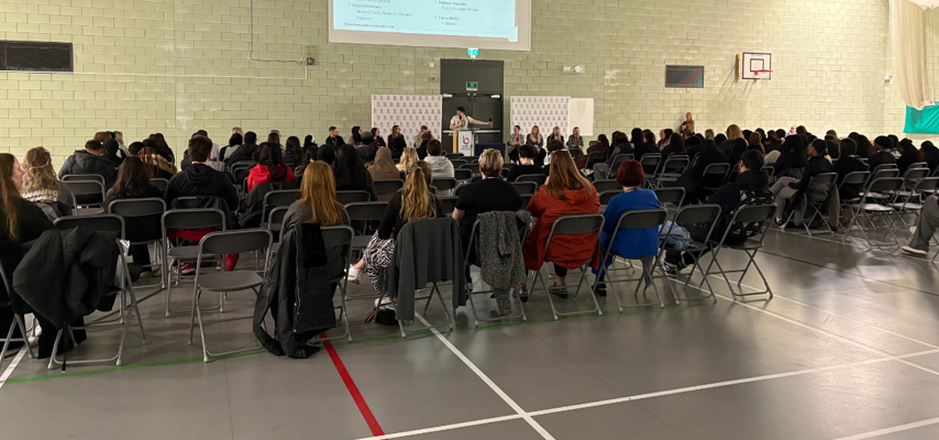 students sat in a talk at an event