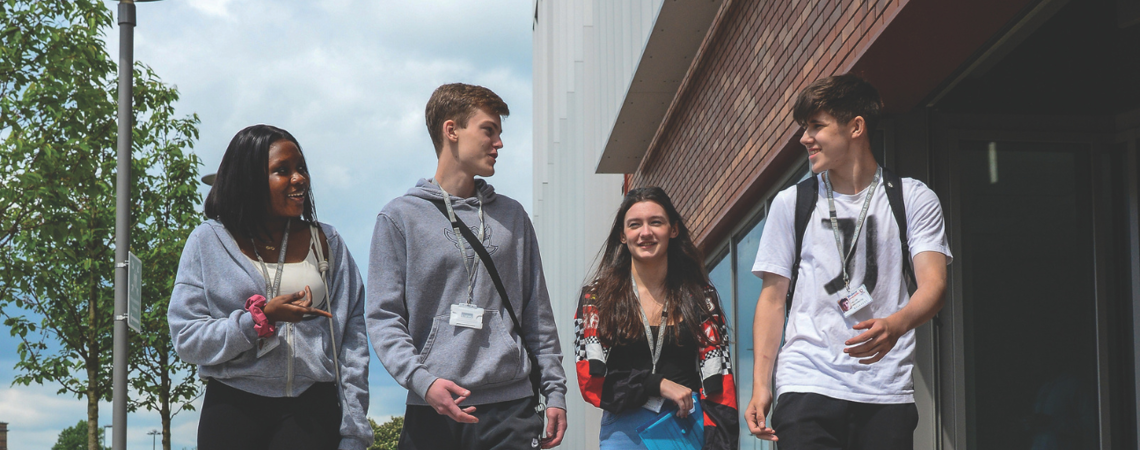 a group of four students walking