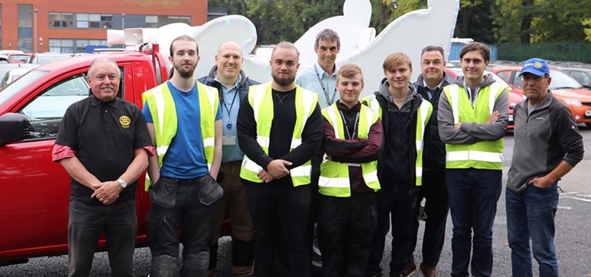 Bury College Carpentry and Joinery students in front of their handcrafted Christmas sleigh