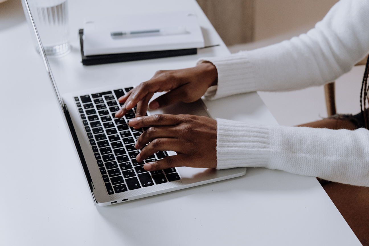 Adult typing on a keyboard