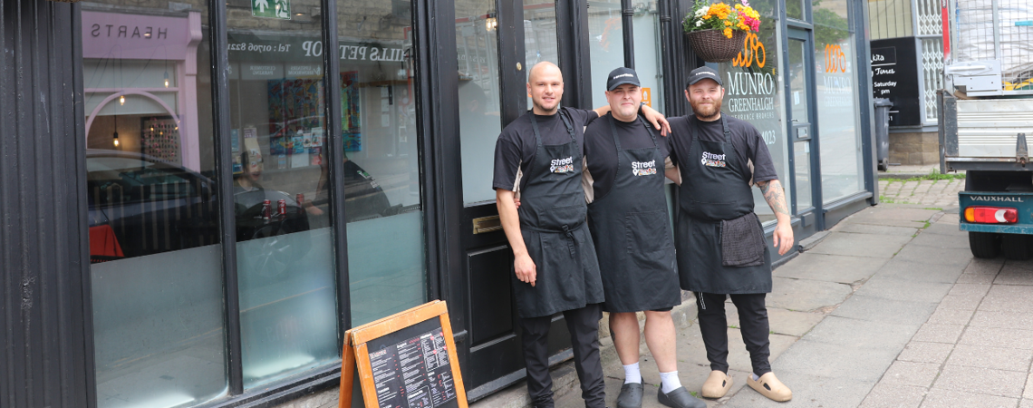 The owners and staff at Street Eats stood outside the restaurant