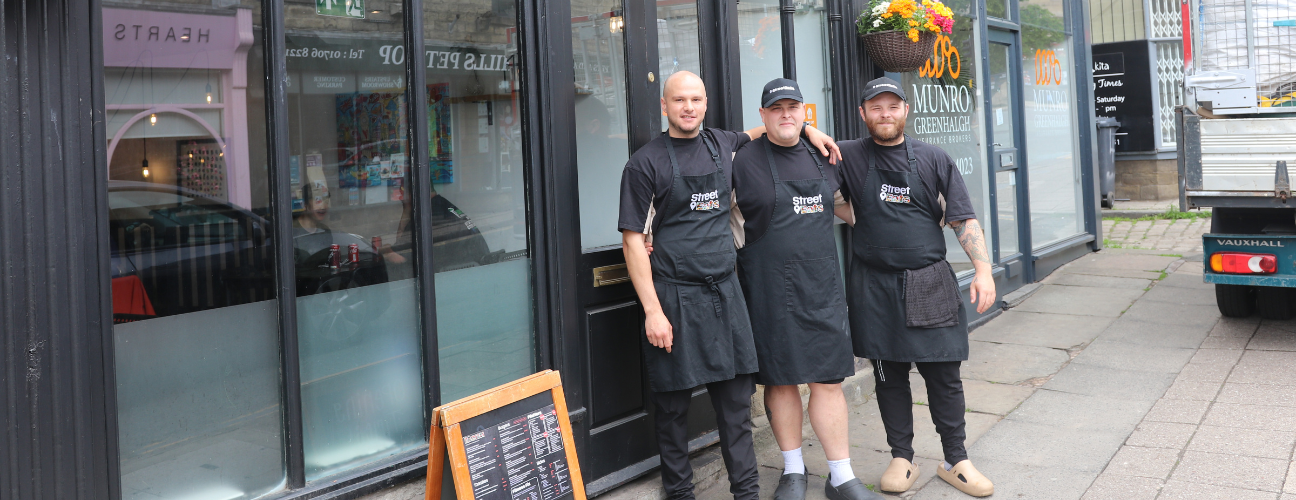 The owners and staff at Street Eats stood outside the restaurant