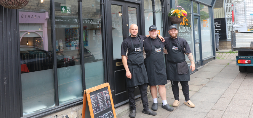 The owners and staff at Street Eats stood outside the restaurant