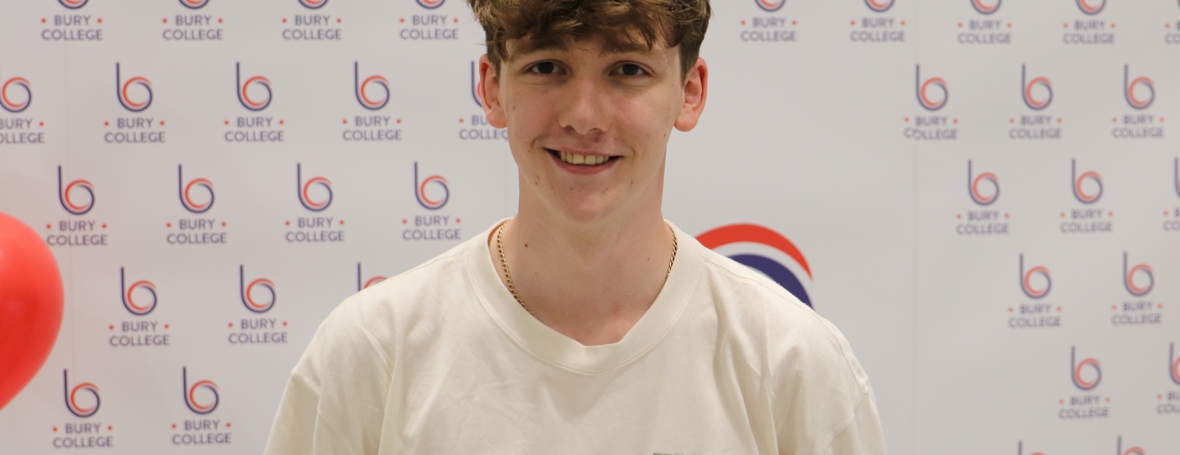 student smiling against Bury College backdrop