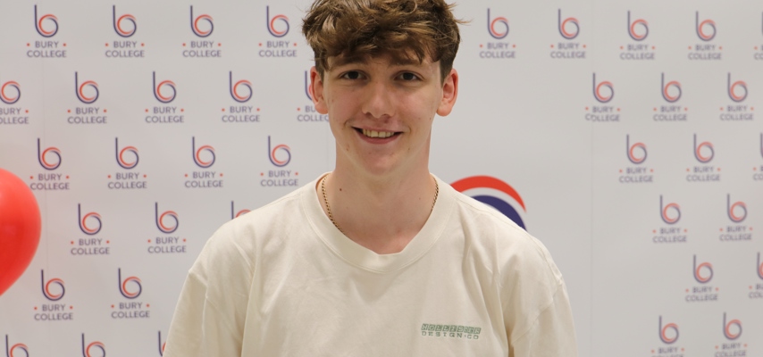 student smiling against Bury College backdrop