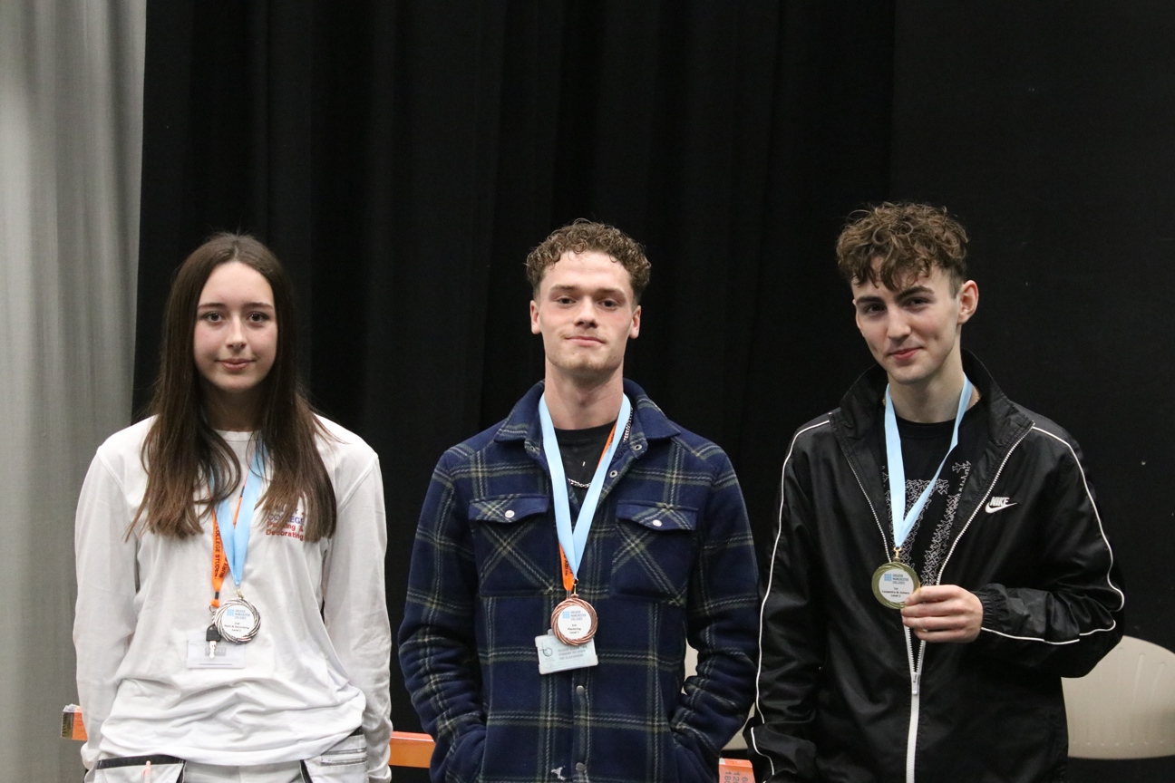 three construction students with their medals