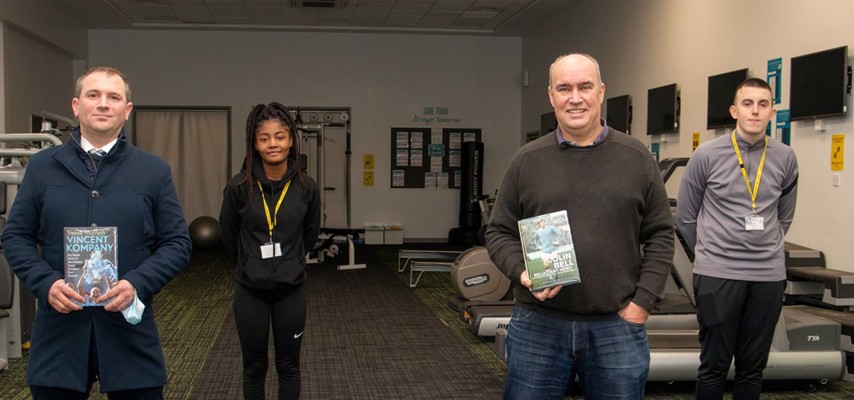 Ian Cheeseman stood with Bury College Sports students
