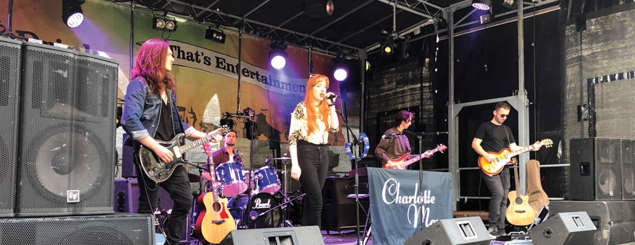 Charlotte Kinsella singing on stage with band