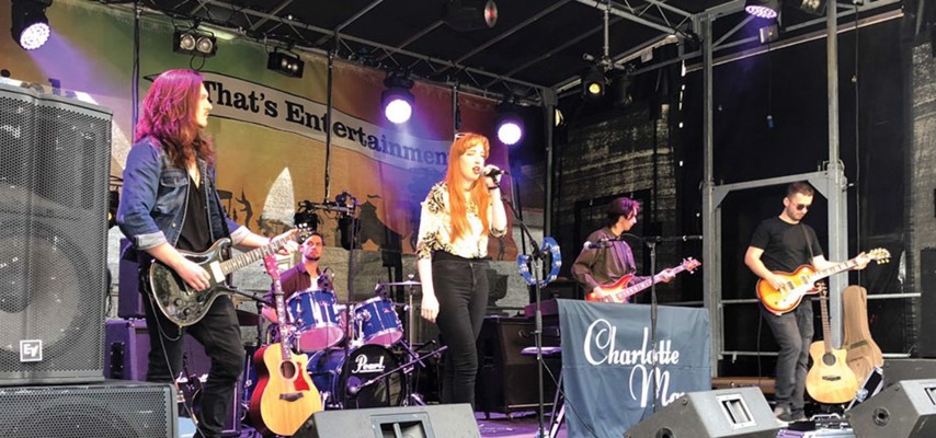 Charlotte Kinsella singing on stage with band