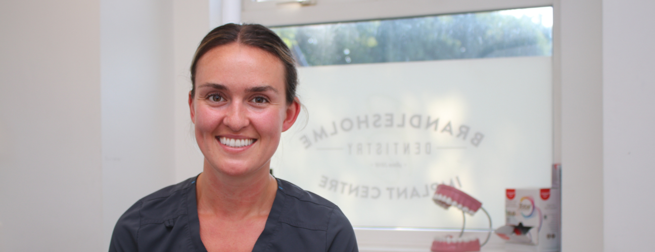 Bury College Dental Apprentice employer smiling at the camera inside the dental practice