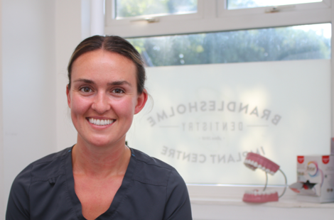 Bury College Dental Apprentice employer smiling at the camera inside the dental practice