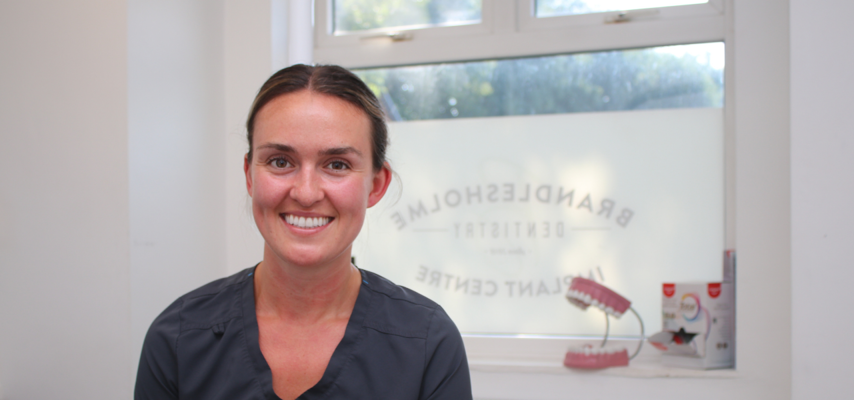 Bury College Dental Apprentice employer smiling at the camera inside the dental practice