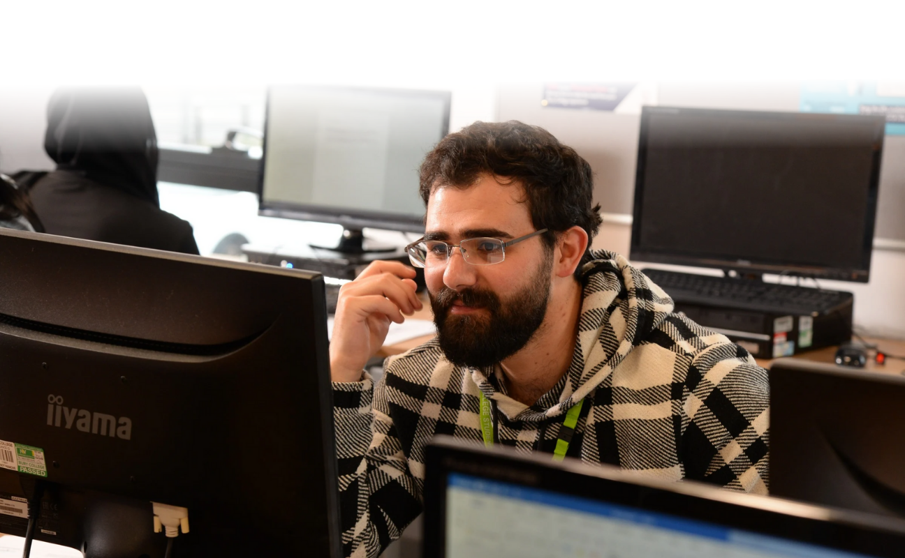 Adult learner working on a computer during lesson