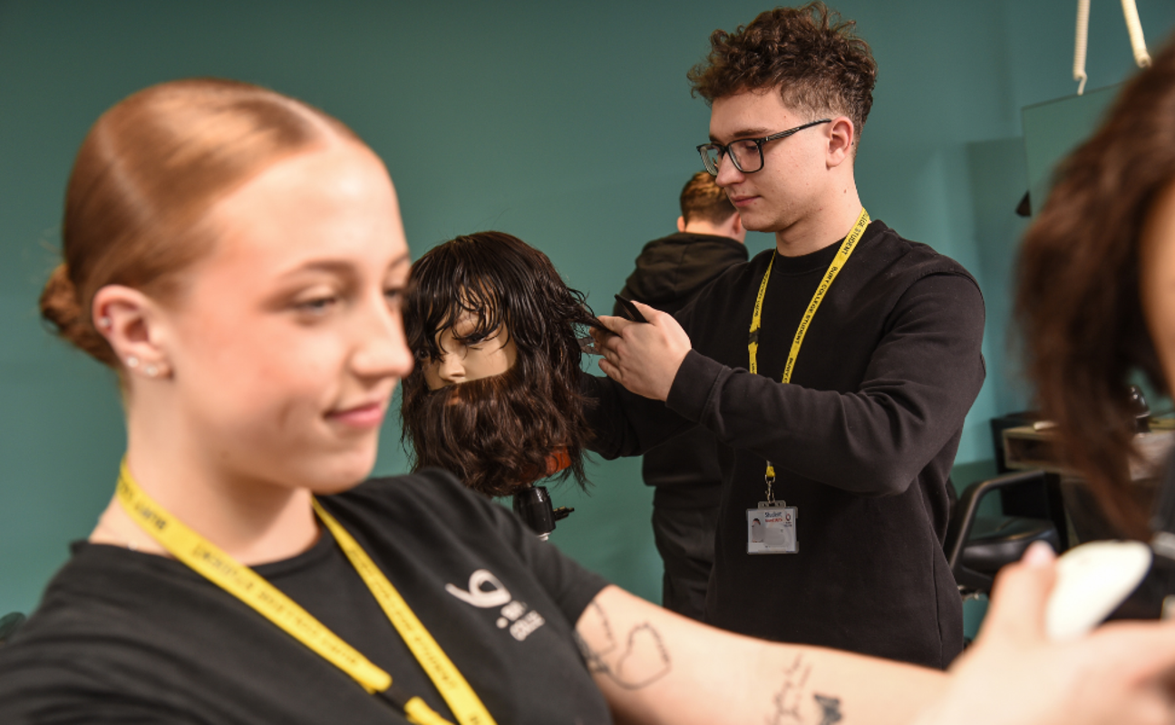 Barbering students taking part in a practical activity
