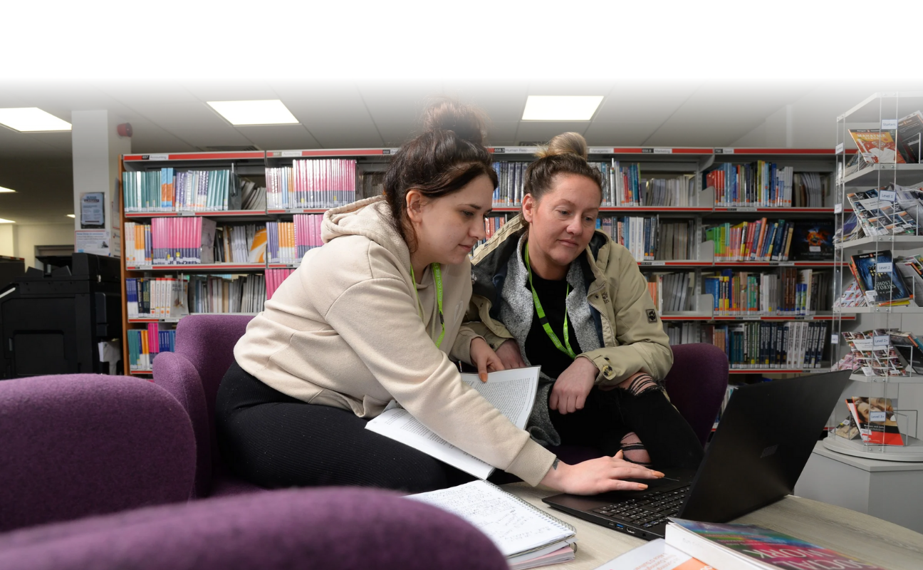 Adult learners studying in the library