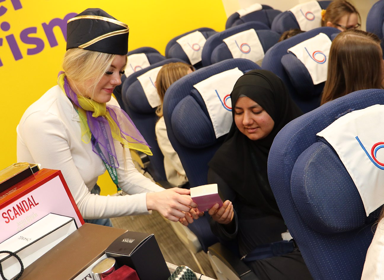 Travel student selling items on a mock plane