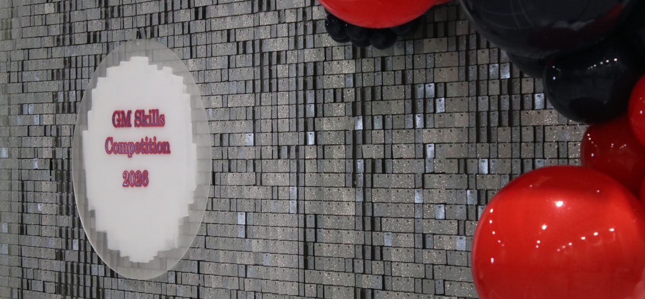 GM Skills Competition sign with sparkly backdrop and balloons